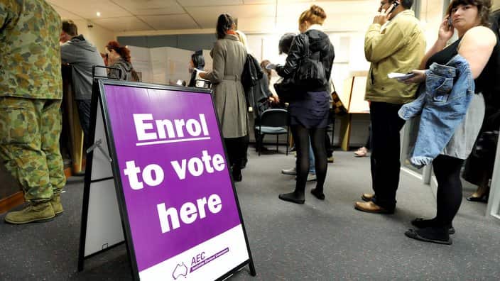 People queue up with their enrolment for