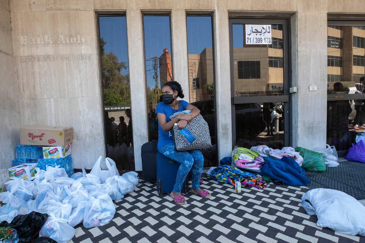 An Ethiopian domestic worker waits in front of the Ethiopian consulate after she and others were abandoned by their Lebanese employers