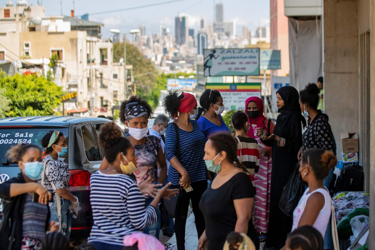 Dozens of Ethiopian domestic workers gather outside the Ethiopian consulate