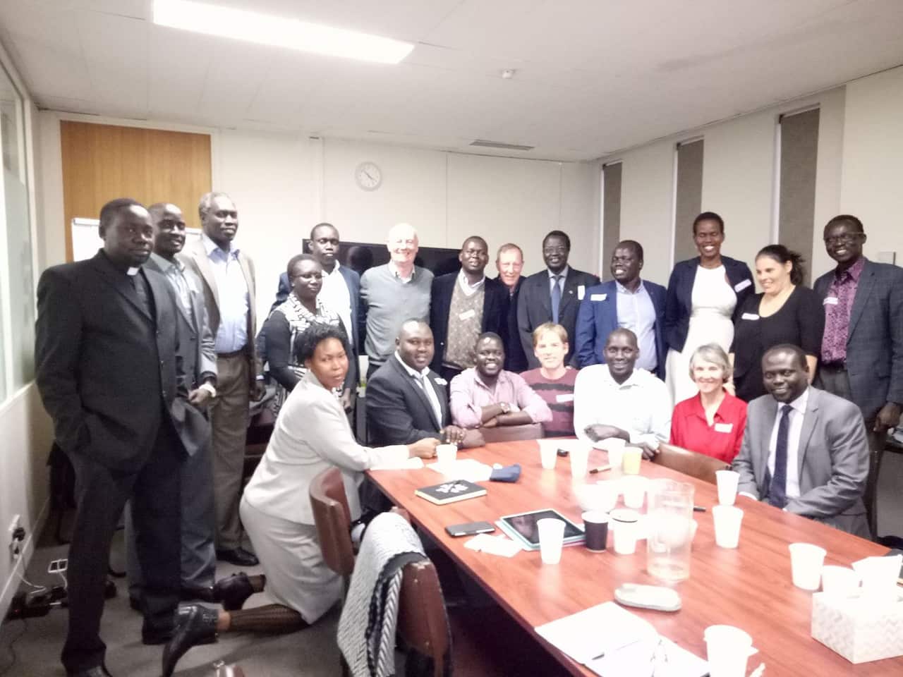 Nyok Gor with other South Sudanese leaders at a national gathering, discussing peace advocacy work in Australia. 