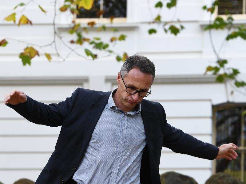 Richard Di Natale heads to a media conference in Melbourne.
