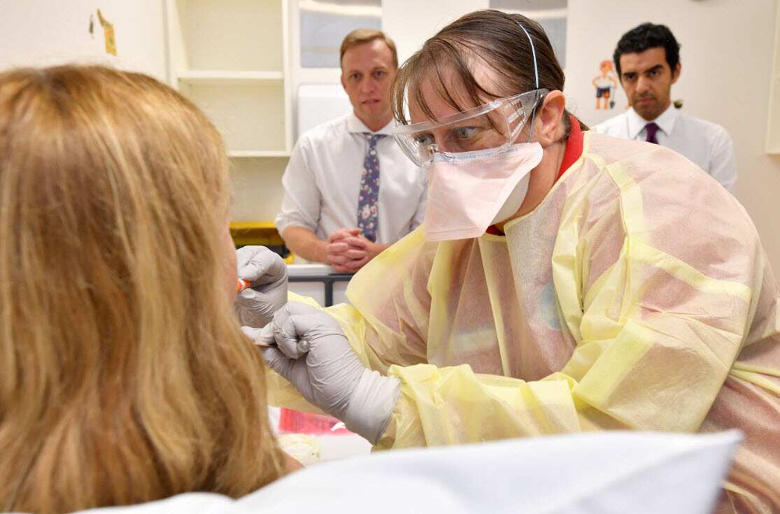  a clinical nurse consultant is seen performing a mock coronavirus examination inside the fever clinic at the Prince Charles Hospital in Brisbane.