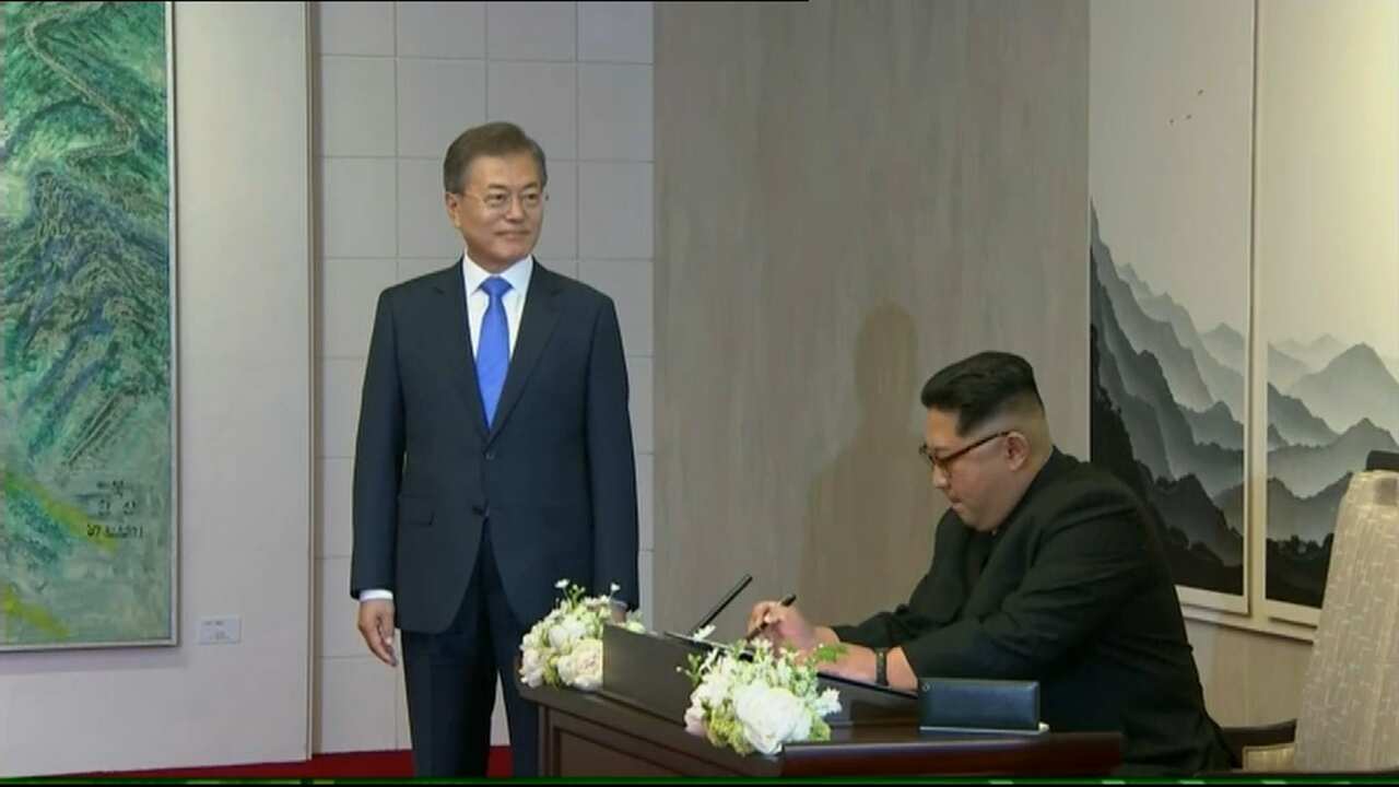 North Korea's Kim Jong-un signs the guest book.