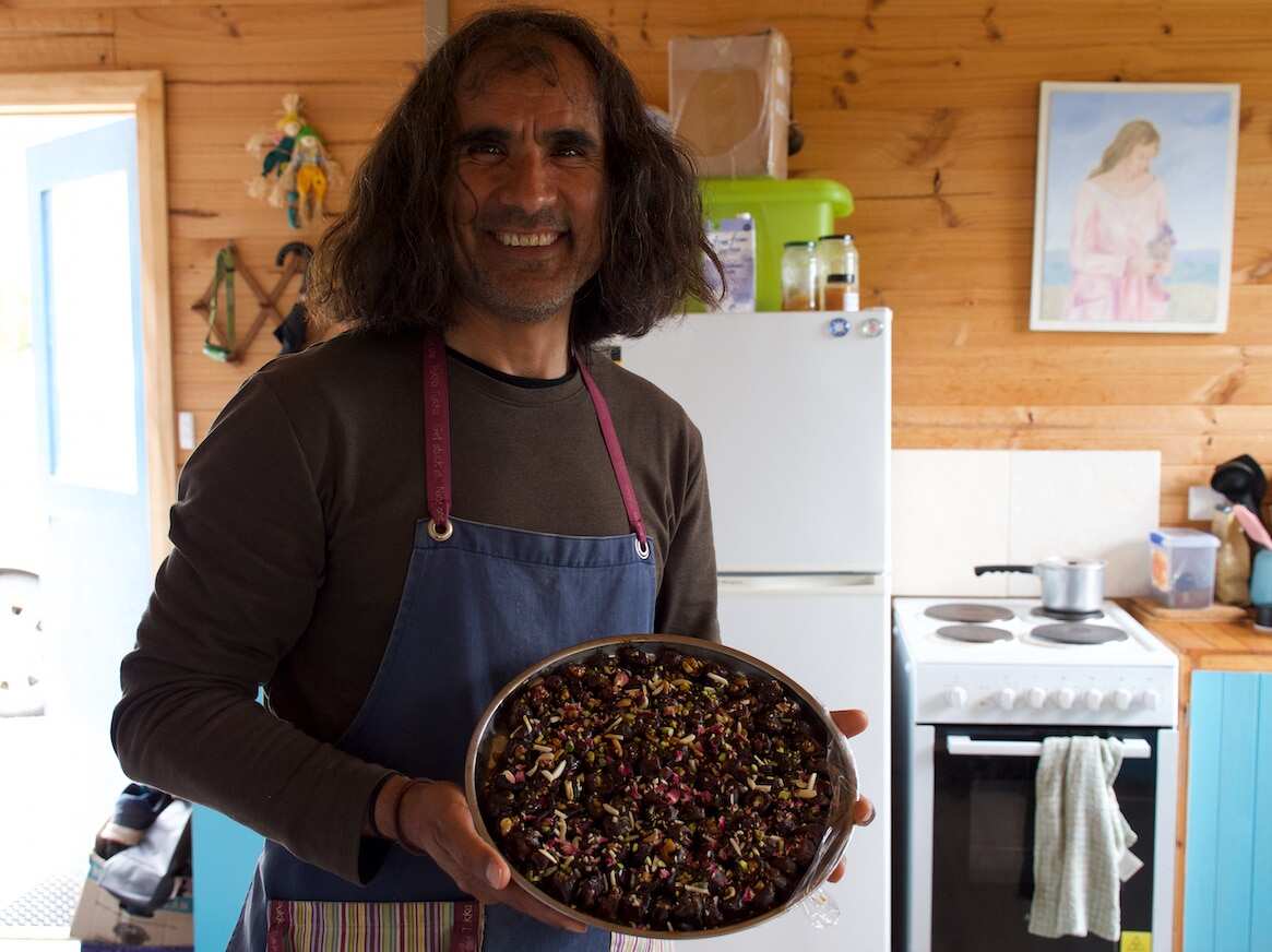 Arad Niksefat at his home, preparing his food to sell at market.