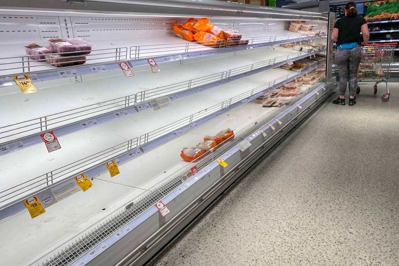 Empty shelves of meat products are seen at a supermarket in Sydney, 7January 2022.