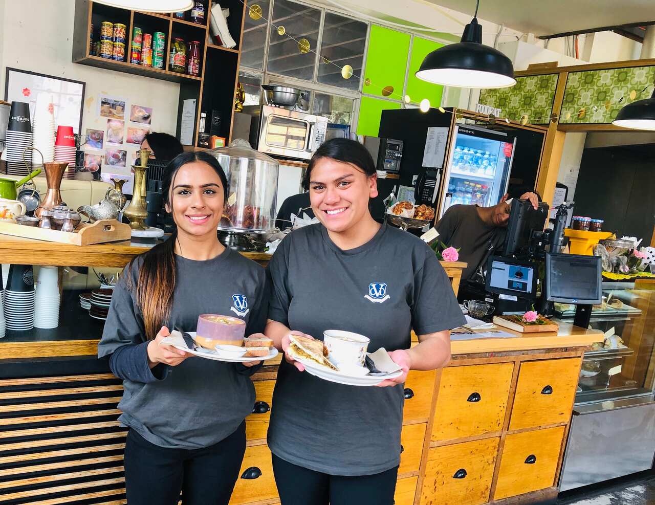Dilpreet and Precious serving food at Tradeblock Cafe.