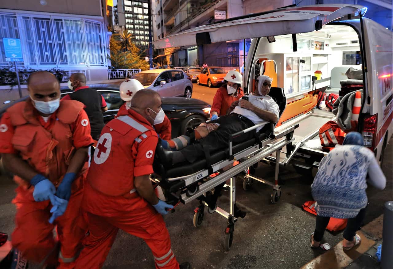 Medics shift an injured person from Najjar Hospital to another hospital in Al-Hamra area in Beirut.