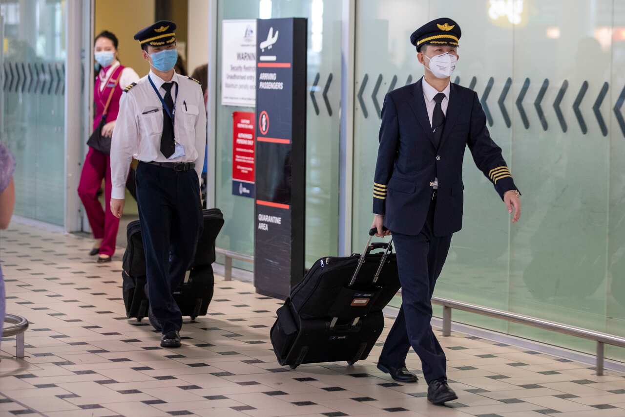 Pilots wearing protective face masks at Brisbane International Airport in Brisbane, Friday, January 31, 2020.
