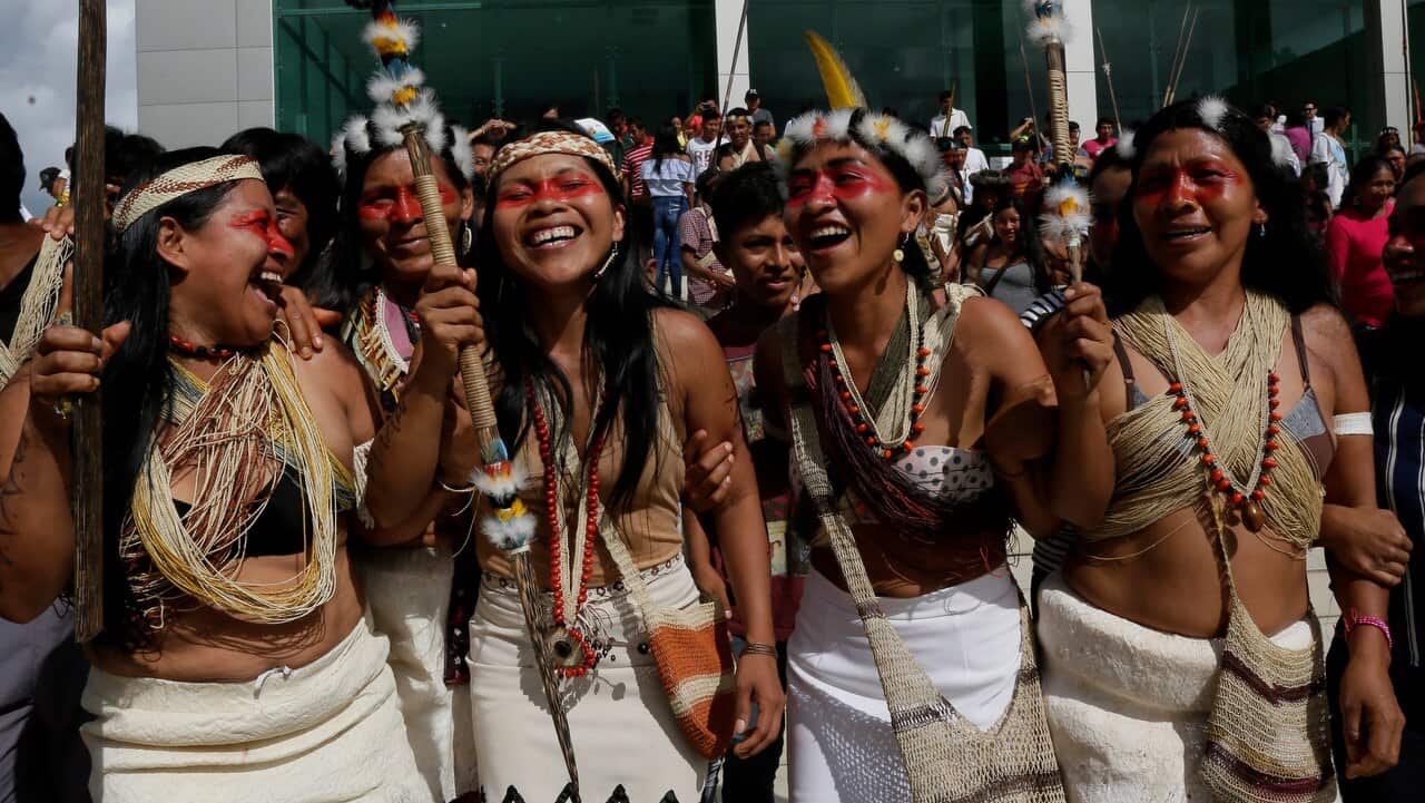 Waoranis and leader Nemonte Nenquimo celebrate after a judged ruled in their favour.