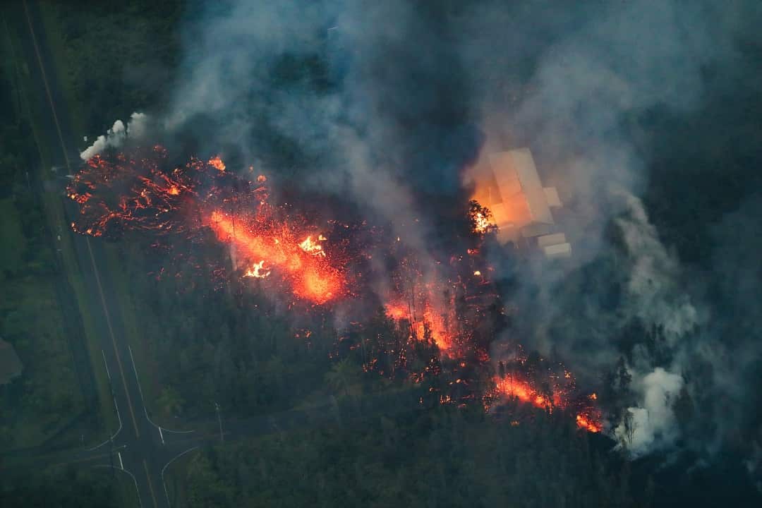 A 2,000 foot long fissure erupts within the Leilani Estates subdivision, igniting a home and creating a black plume of smoke in Hawaii.