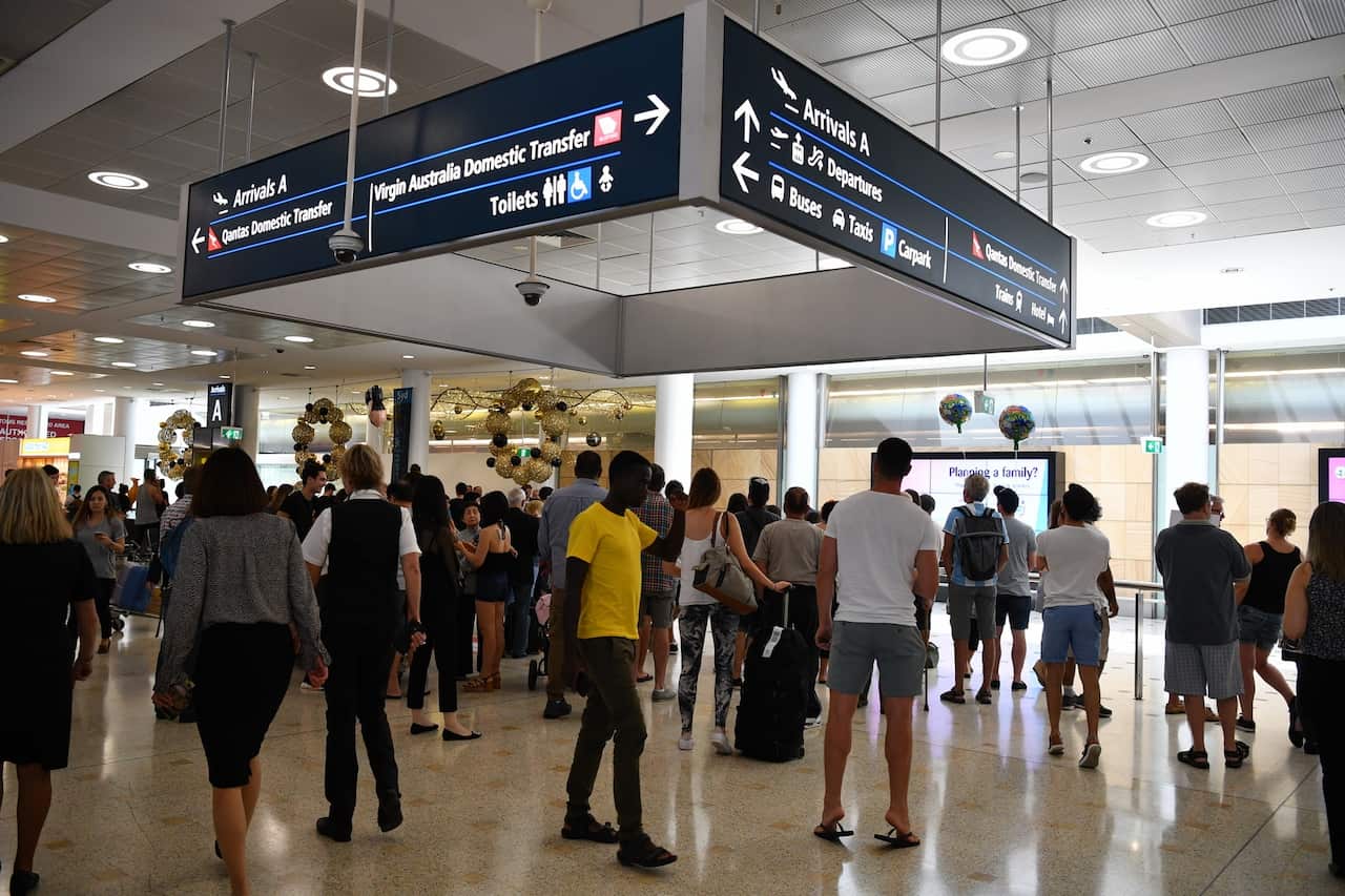 Travellers are seen at Overseas Arrivals and Departures at Sydney's International Airport