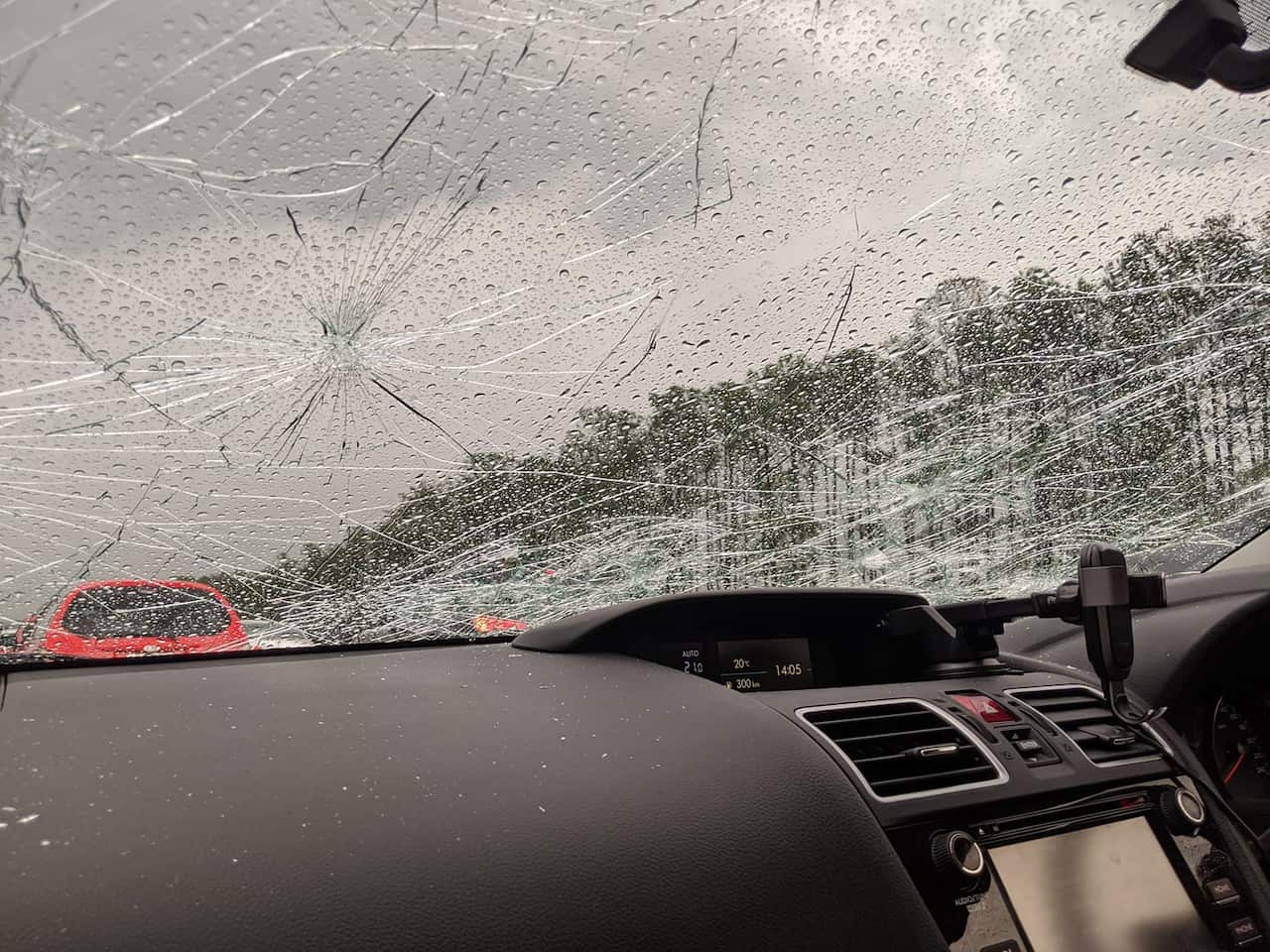 A car windshield with damage sustained from hail stones in south-east Queensland Zac Lemon/Facebook
