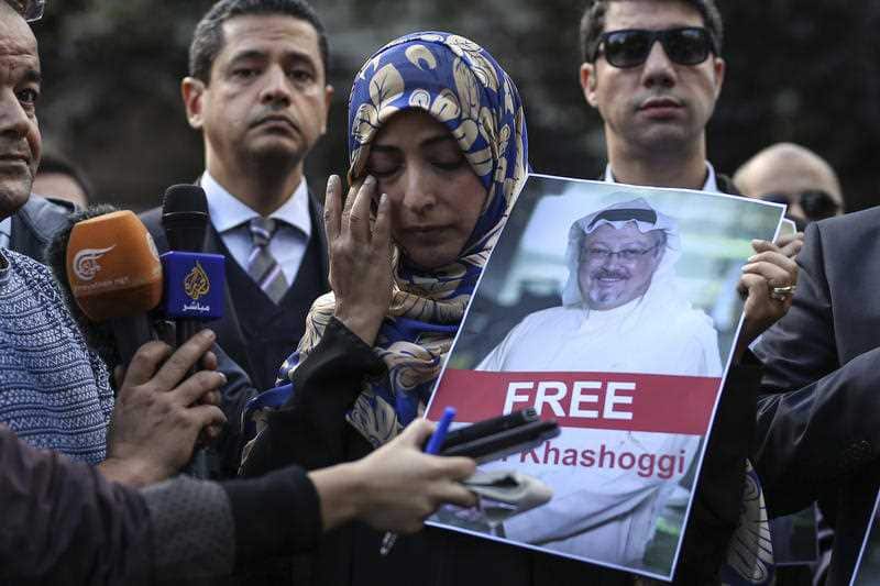 Saudi writer Jamal Khashoggi holds a photo of the missing Saudi journalist Jamal Khashogg.