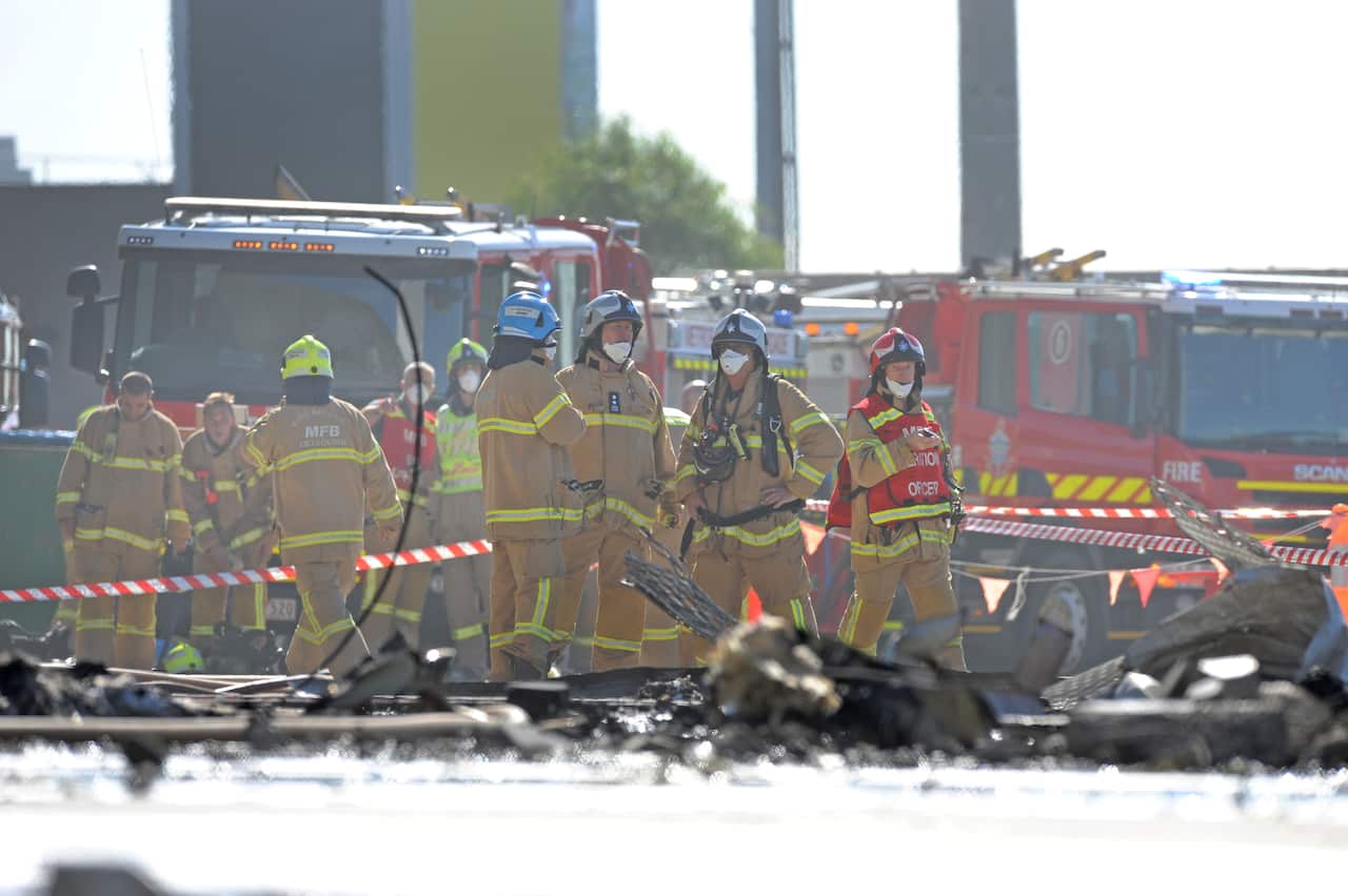 Emergency services at the scene where a light plane crashed into the back of a DFO building at Essendon airport in Melbourne, Tuesday 21, 2017. (AAP Image/Joe Castro) NO ARCHIVING