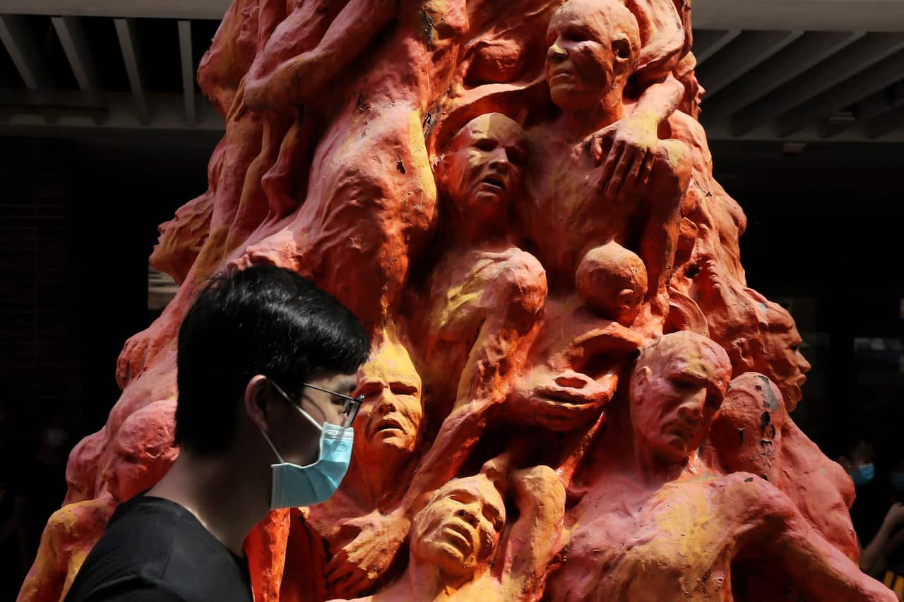 A university student walks past the "Pillar of Shame" statue, a memorial for those killed in the 1989 Tiananmen crackdown, at the University of Hong Kong.