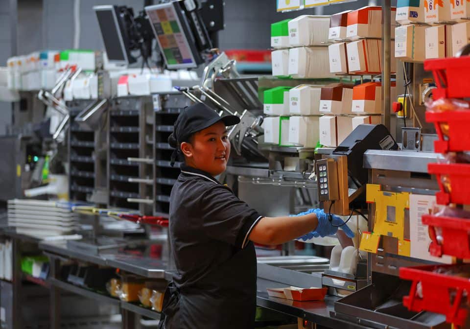 An employee takes part in preparations before the opening of a new restaurant, following McDonald's Corp company's decision to sell its restaurants in Russia