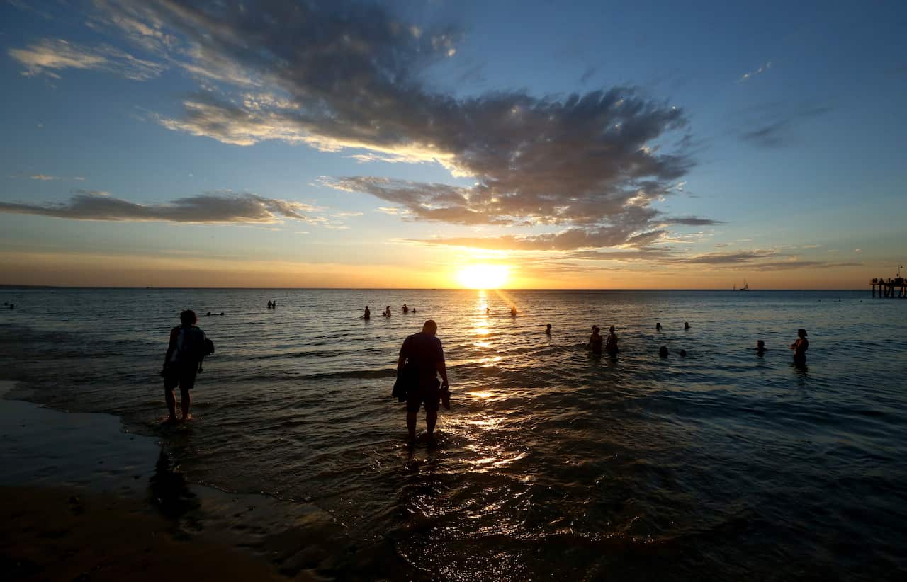 Adelaide residents try and cool off at Glenelg Beach, with the state set to suffer through another heat wave. 