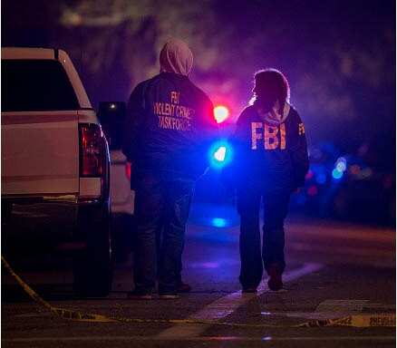 FBI and local officers at the scene, following the shooting which left 13 people dead.