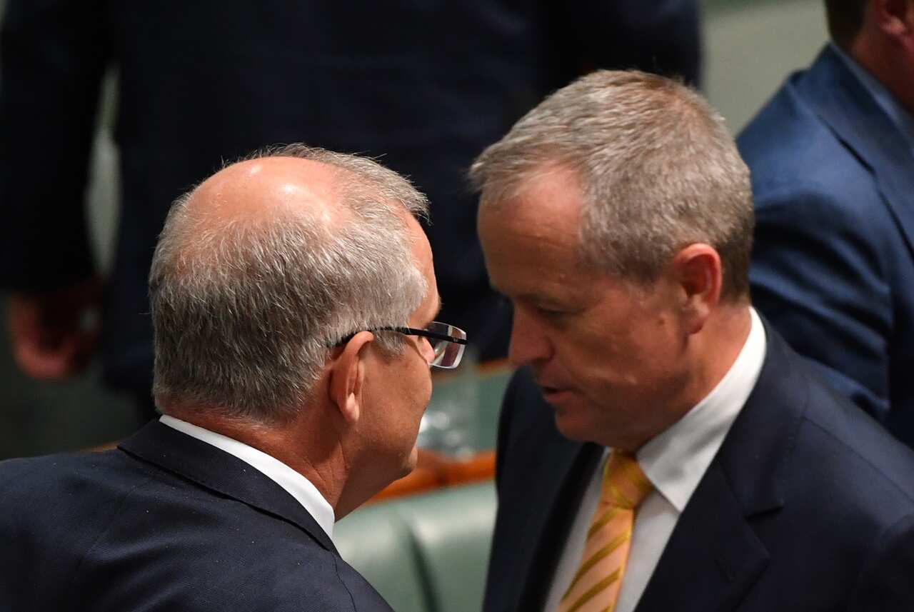 Prime Minister Scott Morrison and Leader of the Opposition Bill Shorten pass each other in a division during Question Time in the House of Representatives at Parliament House in Canberra, Thursday, November 29, 2018. (AAP Image/Mick Tsikas) NO ARCHIVING