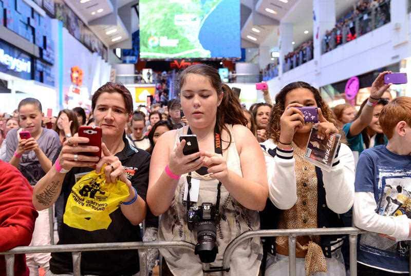 Stock photograph of shoppers using mobile phones at Chermiside Shopping Centre, in Brisbane, Wednesday, June 27, 2012. (AAP Image/Dave Hunt) NO ARCHIVING