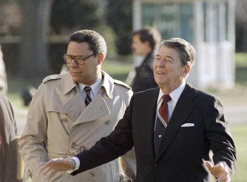 US President Ronald Reagan, accompanied by Colin Powell, leaves the White House in Washington, Dec. 16, 1988