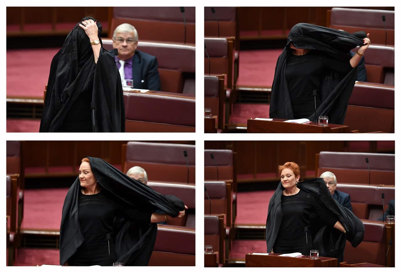 A combined picture of One Nation Senator Pauline Hanson taking off a burqa during Senate Question Time at Parliament House in Canberra.