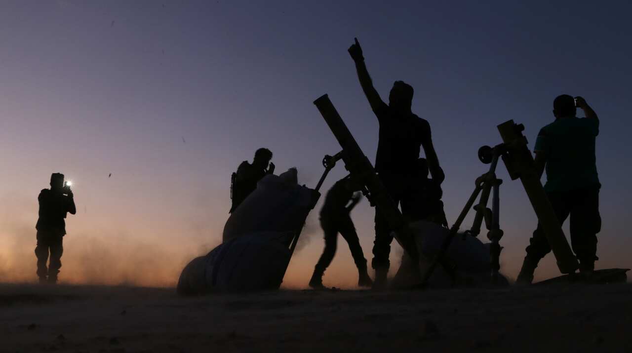Fighters from the Free Syrian Army cheer and react as they fight against the IS group jihadists on the outskirts of the northern Syrian town