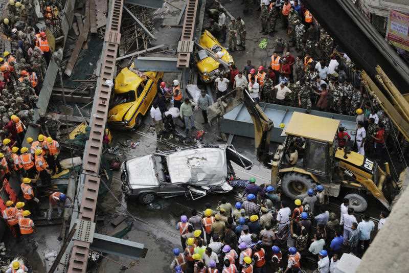 Rescue workers work at the site of a partially collapsed overpass in Kolkata, India,Thursday, March 31, 2016.