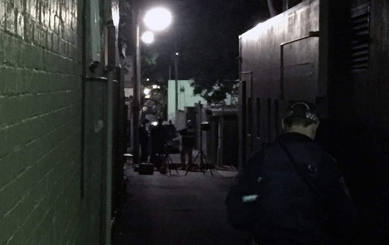 NSW Police and forensic officers in Goodlet Lane at the rear of a property that was raided as part of a counter-terrorism operation in Cleveland Street in Surry Hills