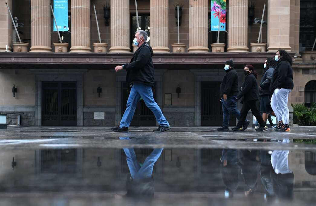 People wearing protective face masks are seen walking through King George Square during lockdown in Brisbane, Thursday, July 1, 2021