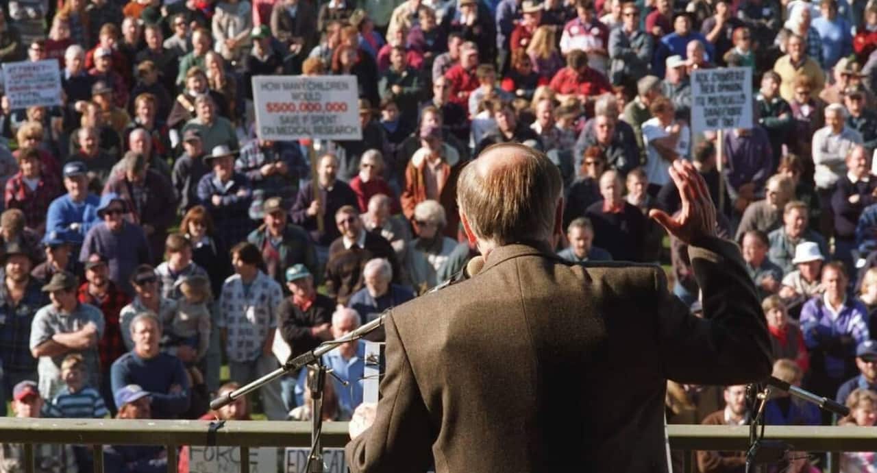 John Howard wears a bulletproof vest in 1996.