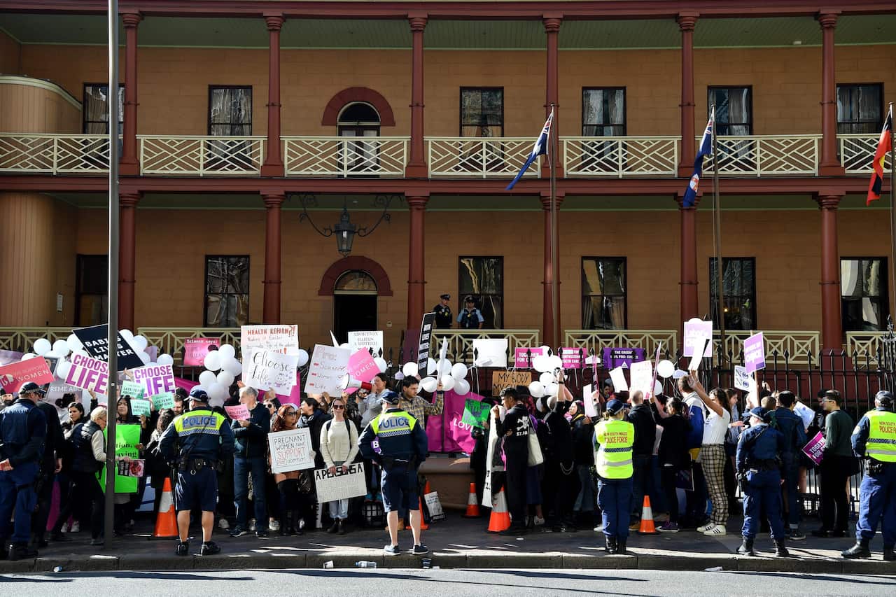 Opposing groups protest outside the New South Wales parliament as abortion legislation is debated.