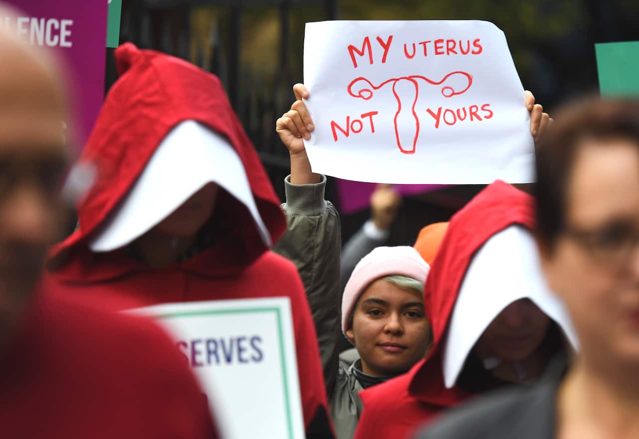 Supporters of creating a safe access zone around abortion clinics in NSW gather outside NSW Parliament House in Sydney