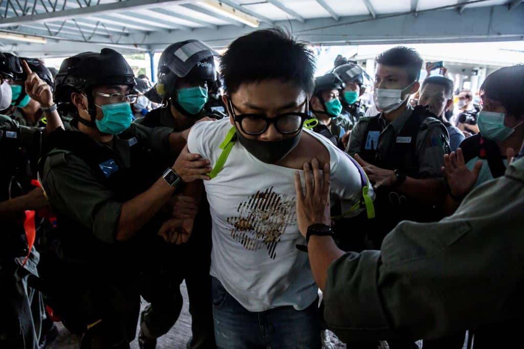TOPSHOT - Police officers arrest a pro-democracy demonstrator (C) during a pro-democracy protest calling for the city's independence in Hong Kong on May 10, 2020. (Photo by ISAAC LAWRENCE / AFP) (Photo by ISAAC LAWRENCE/AFP via Getty Images)