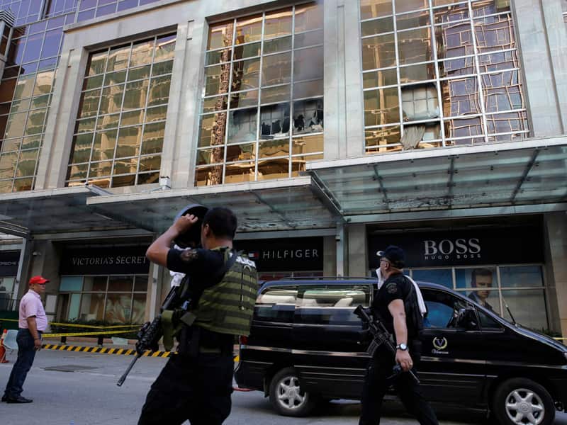 Policemen outside the Resorts World Manila