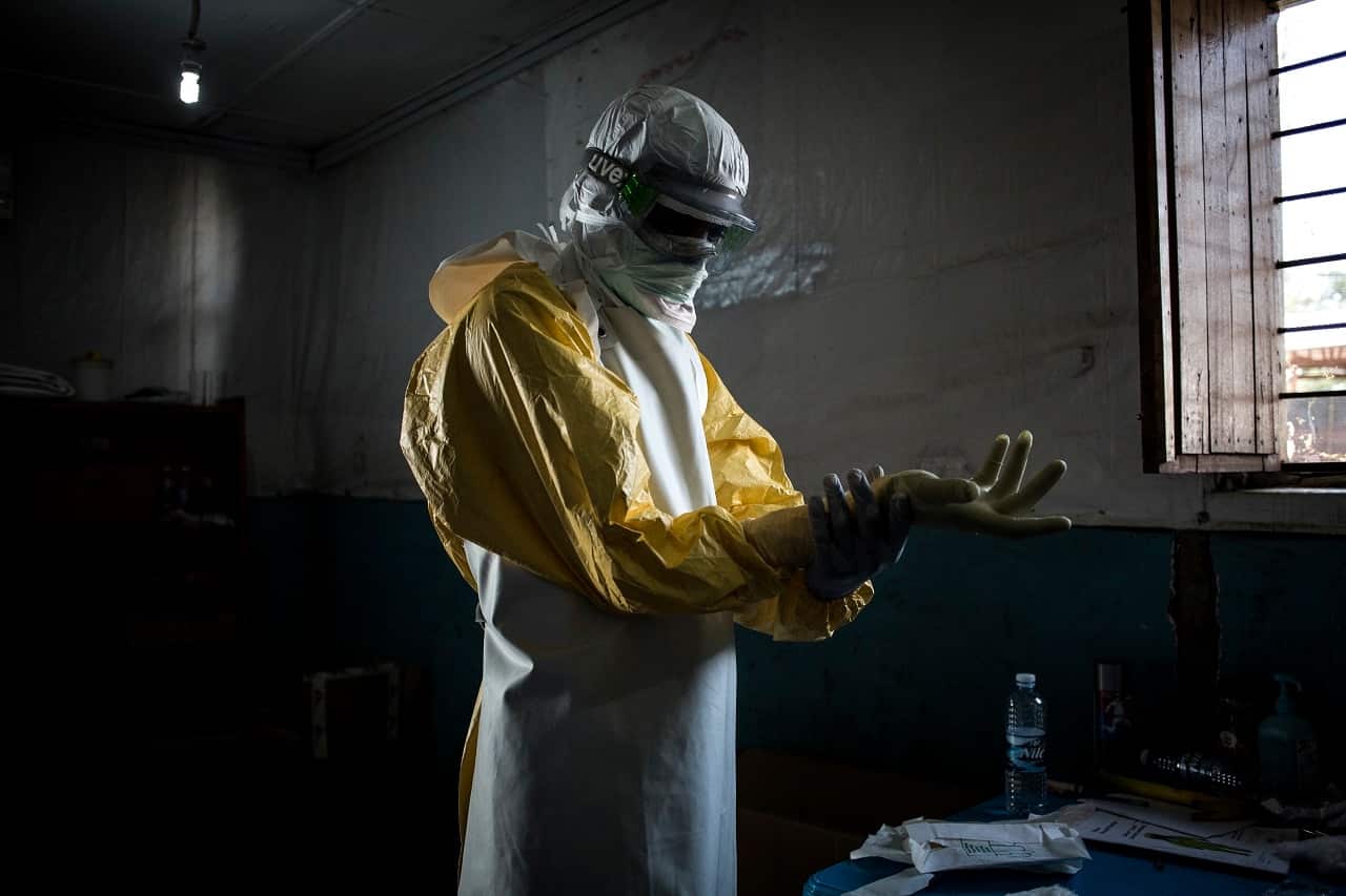 A health worker put on his personal protective equipment before entering a "red zone".