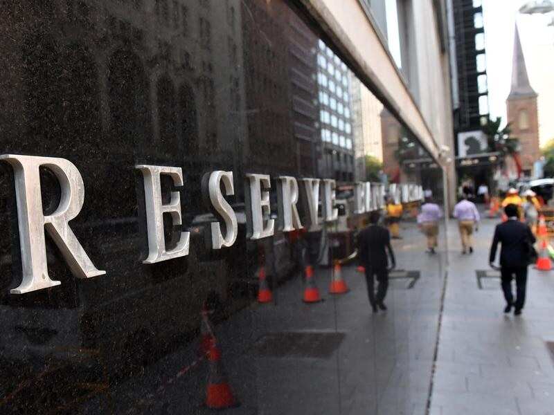 A pedestrian walks past the Reserve Bank of Australia in Sydney