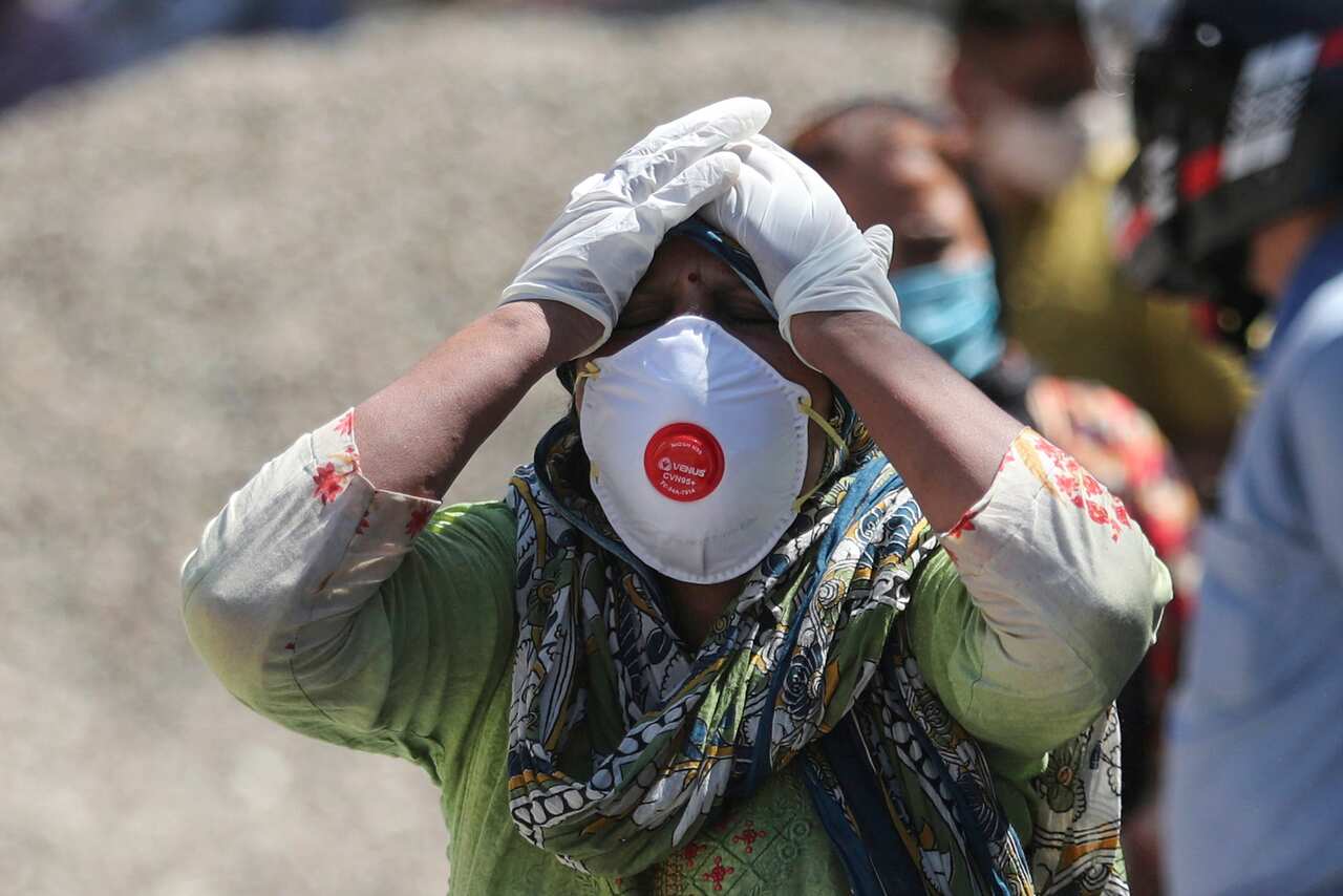 A relative of a person who died of COVID-19 reacts at a crematorium in Jammu, India, Sunday, 25 April, 2021.