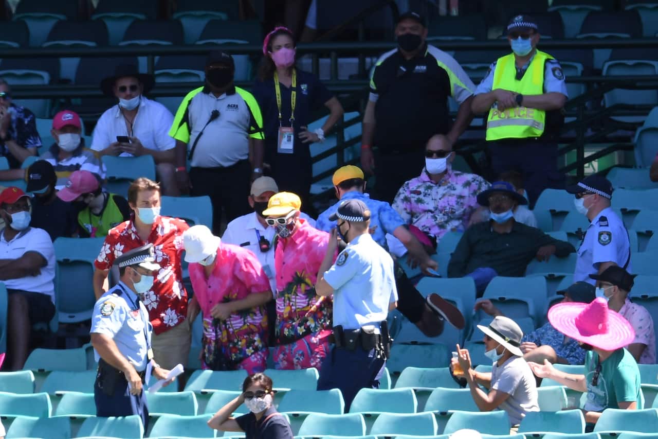 Police remove a group of spectators from their seats at the SCG.