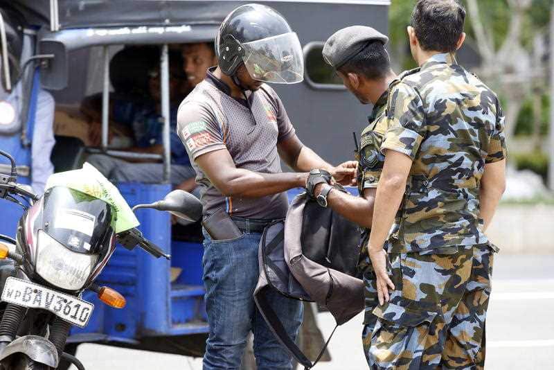 Sri Lankan security personnel check vehicles and bags in Colombo, Sri Lanka.