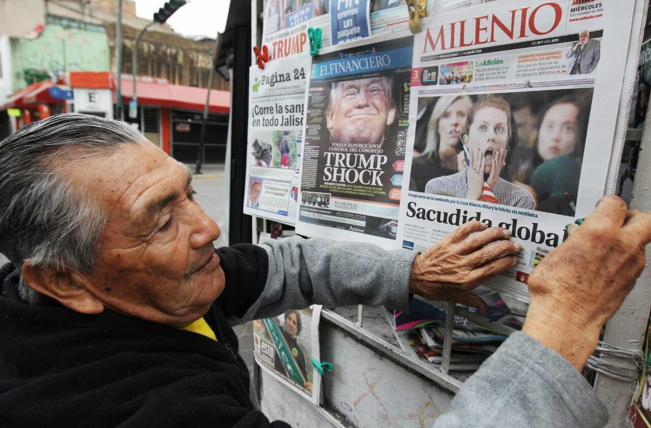 A man sells newspapers showing information about the election of Donald Trump as President of the United States in Guadalajara, Mexico, 09 November 2016. (AAP) 