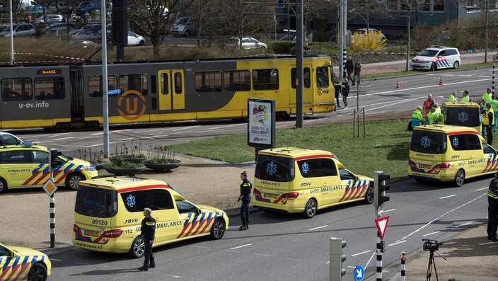 Ambulances are parked next to a tram after a shooting incident in Utrecht, Netherlands 