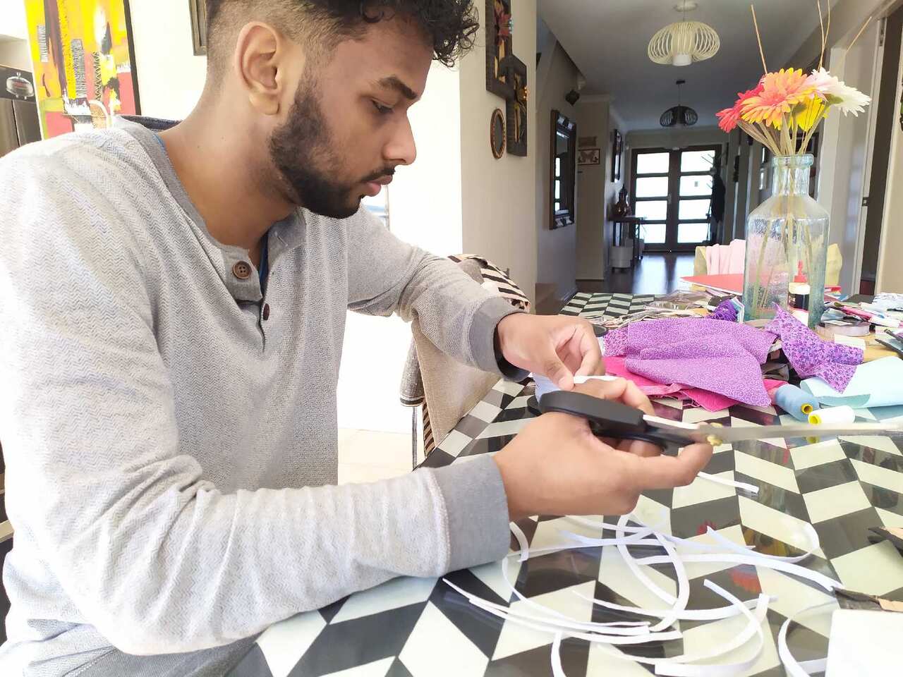 Soheli gets help from her son in producing facemask.