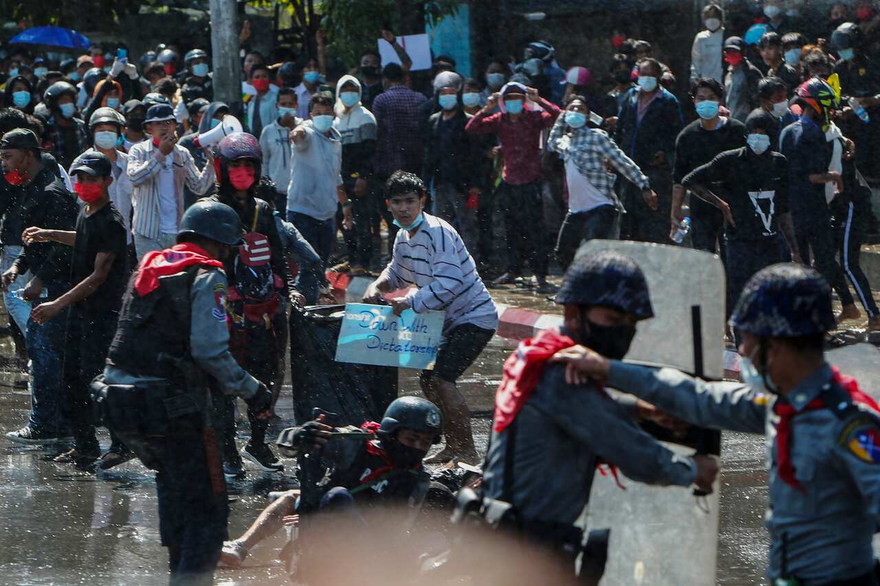 Protesters in Mandalay run after police fire warning shots and use water-cannons