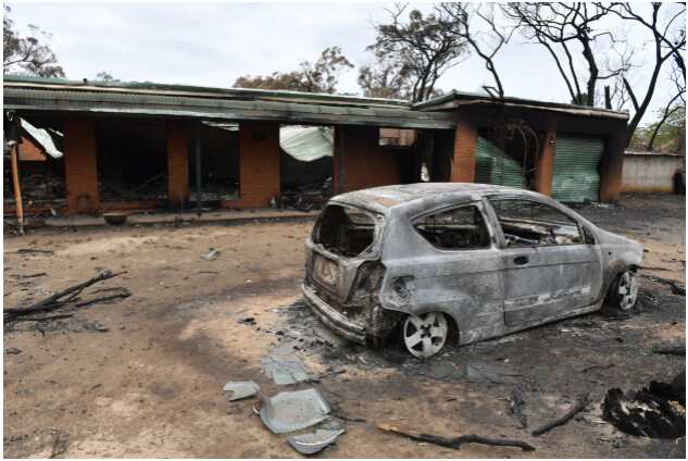 A house and car damaged by last Saturday's catastrophic bushfires in the Southern Highlands village of Balmoral. AAP