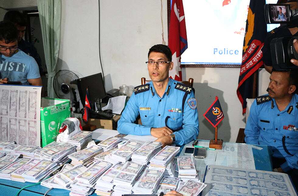 Nepal police display seized fake Nepali notes.