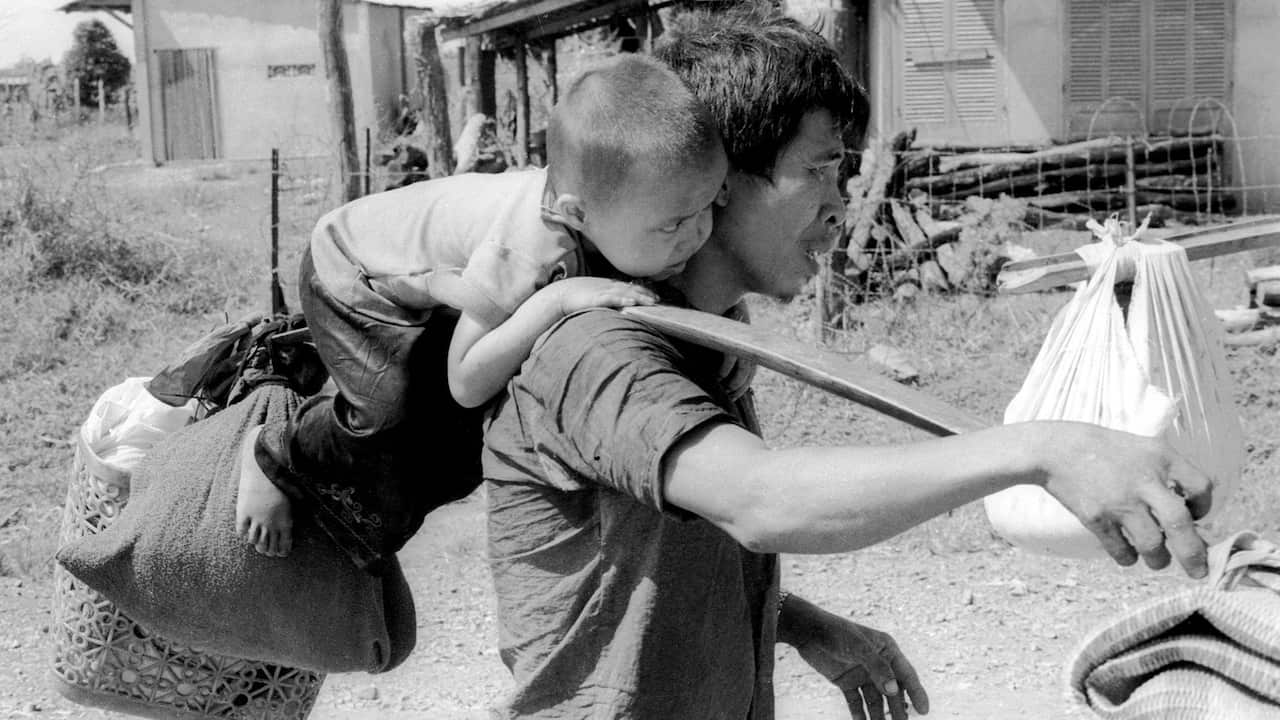 A father and son trying to leave Saigon after its fall 