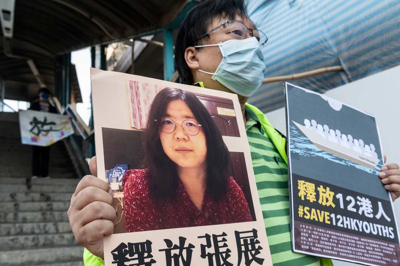 A pro-democracy activist holds up a signs in support of Chinese citizen journalist Zhang Zhan in Hong Kong.