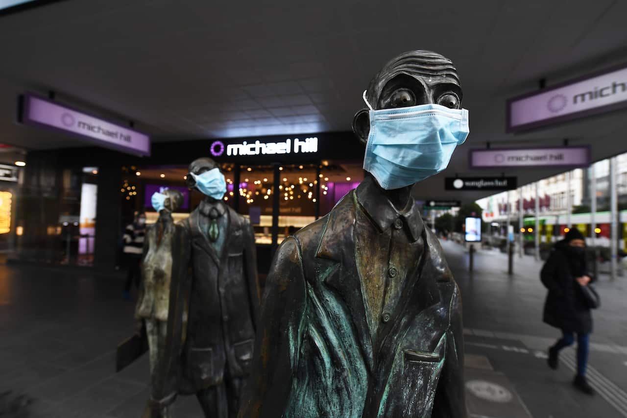 Masks are seen on a statue along Swanston Street in Melbourne's CBD.