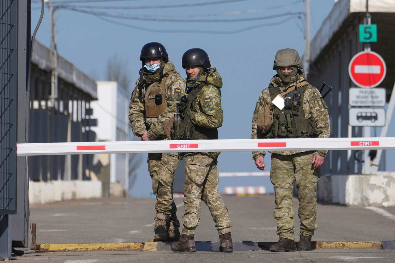 Ukrainian border guards stand at a checkpoint in Novotroitske, eastern Ukraine.